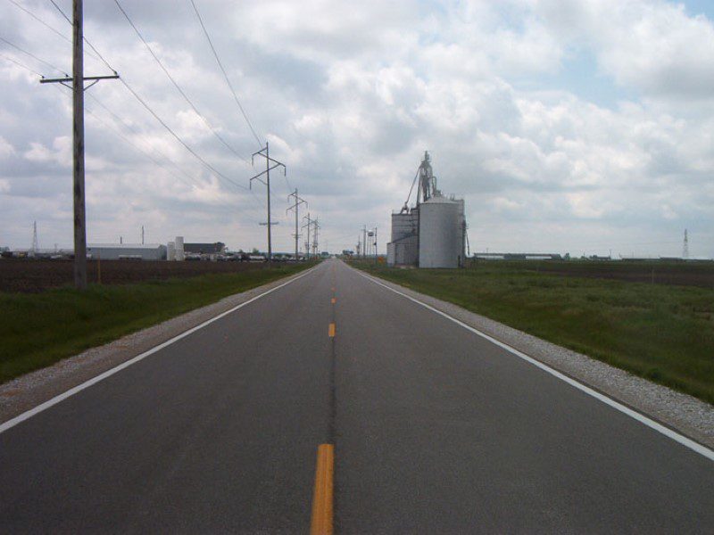 A road with a sky background and clouds