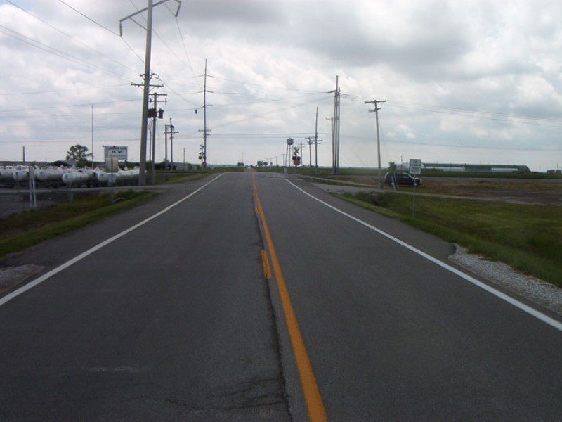 A road with power lines on both sides of the street.