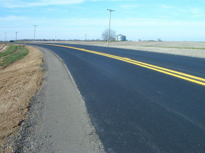 A road with yellow lines on the side of it.