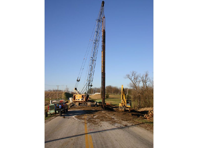 A large crane is on the side of a road.