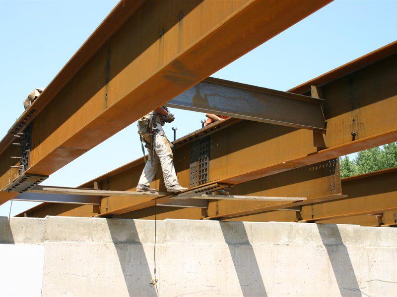 A building being built with metal beams and concrete