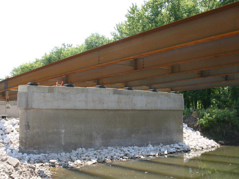 A bridge with concrete and wood on the side.